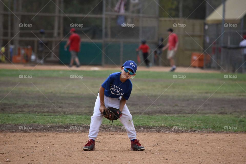 Pitcher wearing gloves in field