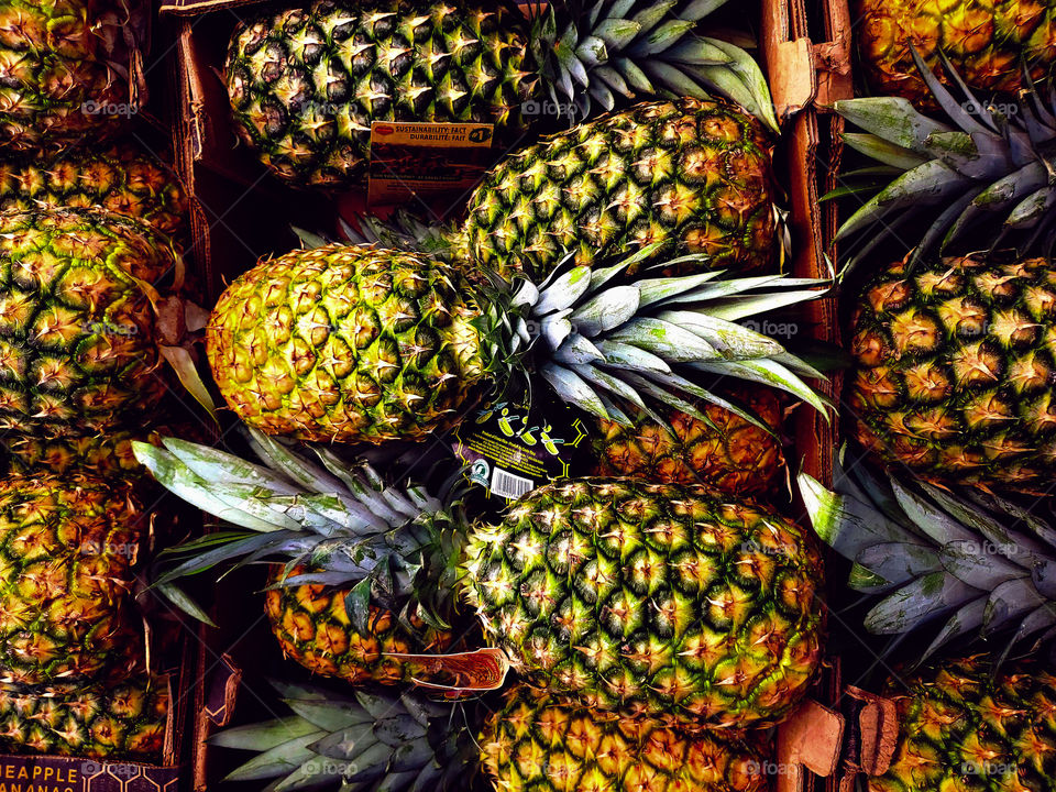 Rich color, pineapples stacked at the market