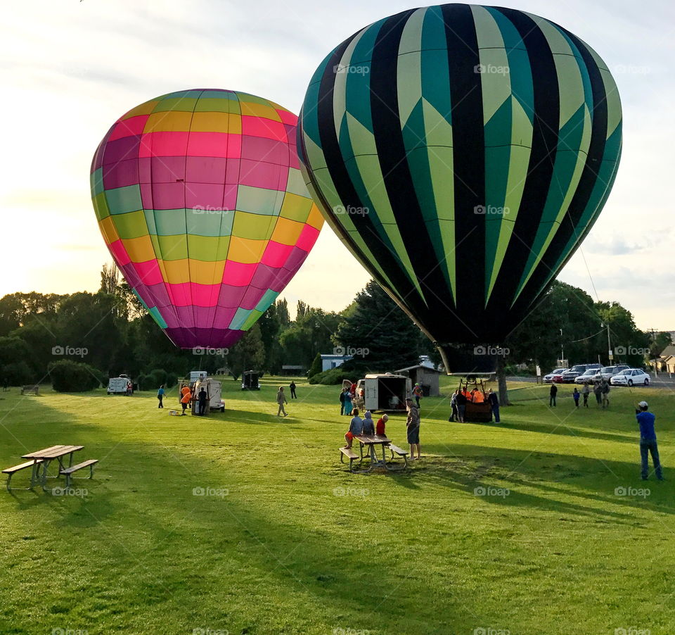Two Hot Air Balloons at dawn in the park in Prineville in Central Oregon ready to take off on a summer morning. 