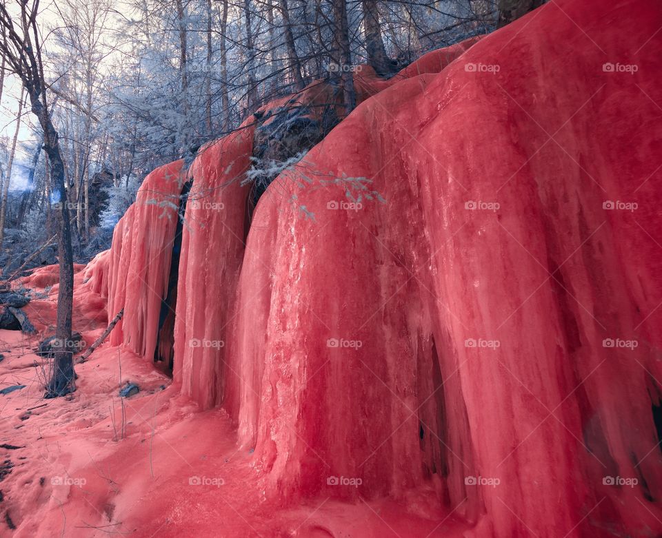 Water trickles endlessly over a frozen hillside. Infrared. Banning State Park, Minnesota.