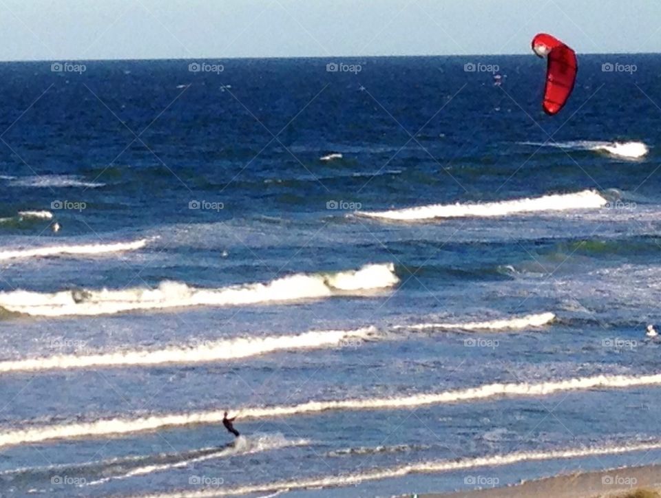 Riding the surf with a kite. East coast Florida beach