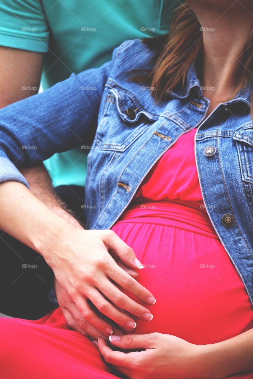 A tender moment between a man and wife as they think of their new bundle of joy. 