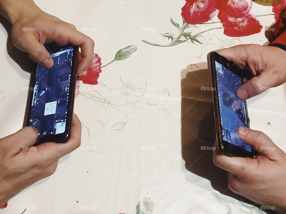 People gaming PUGB with smartphones