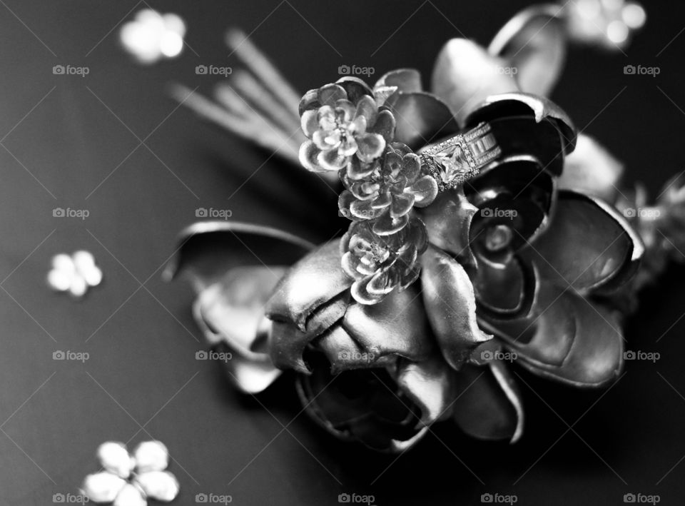 A Diamond ring on an artificial rose in black and white