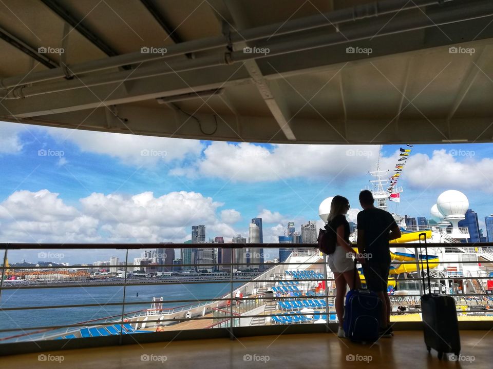 Couple on cruise ship with Singapore skyline background