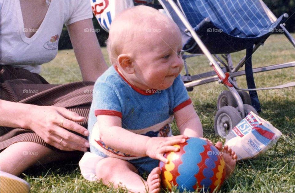 Happy baby playing with ball 
