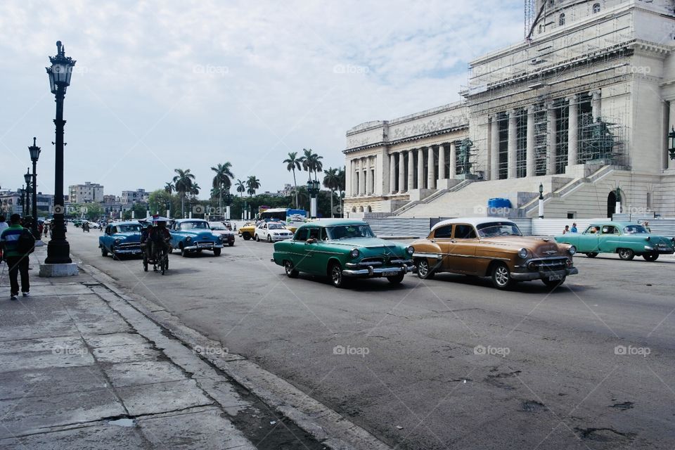 Cuban traffic with old cars outside capitolio