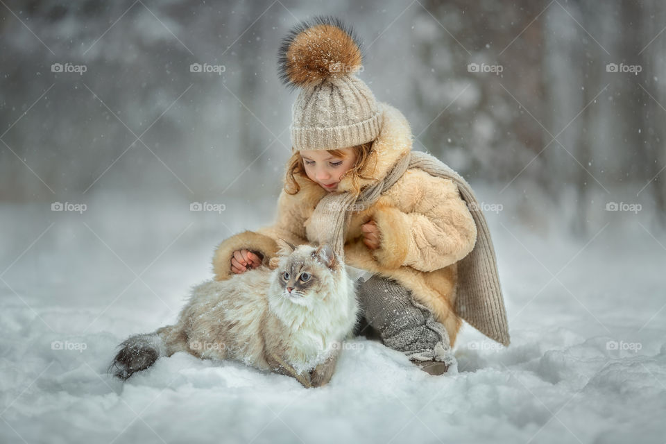 Little girl portrait with cat, winter outdoor 