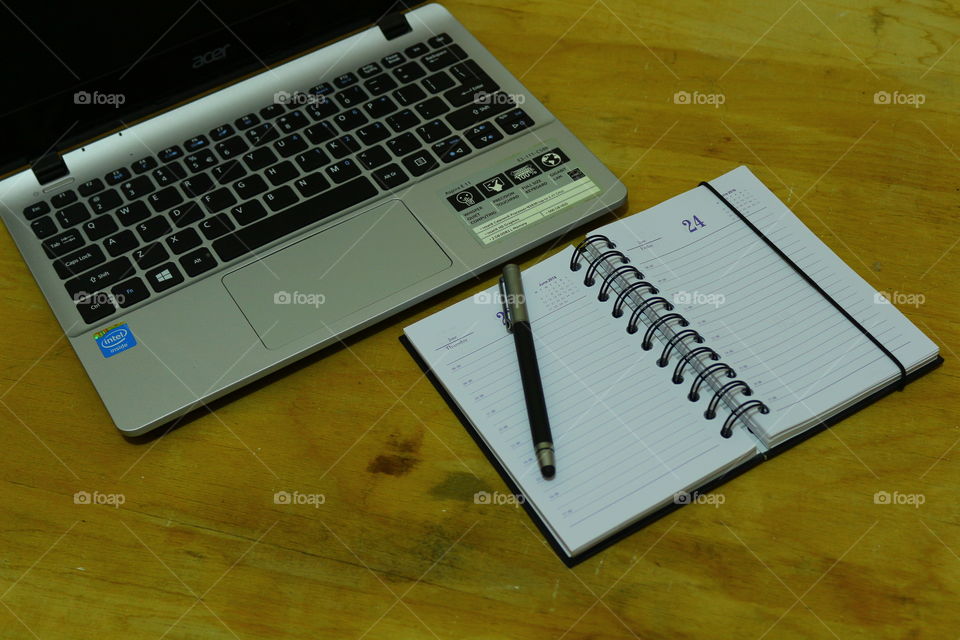 laptop and notebook and pen