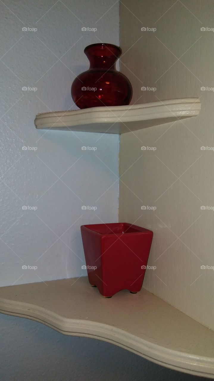 Small Red Vases on Shelves