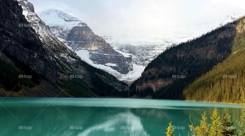 Snowy mountain reflected in lake