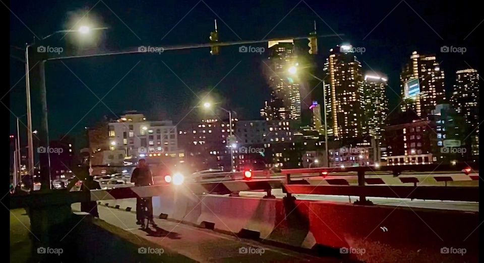 The nighttime illumination makes this already magical city appear even more mesmerizing. This picture was taken on top of the „Pulaski Bridge“ on the LIC, Queens side. 2023. Hypnotic Productions