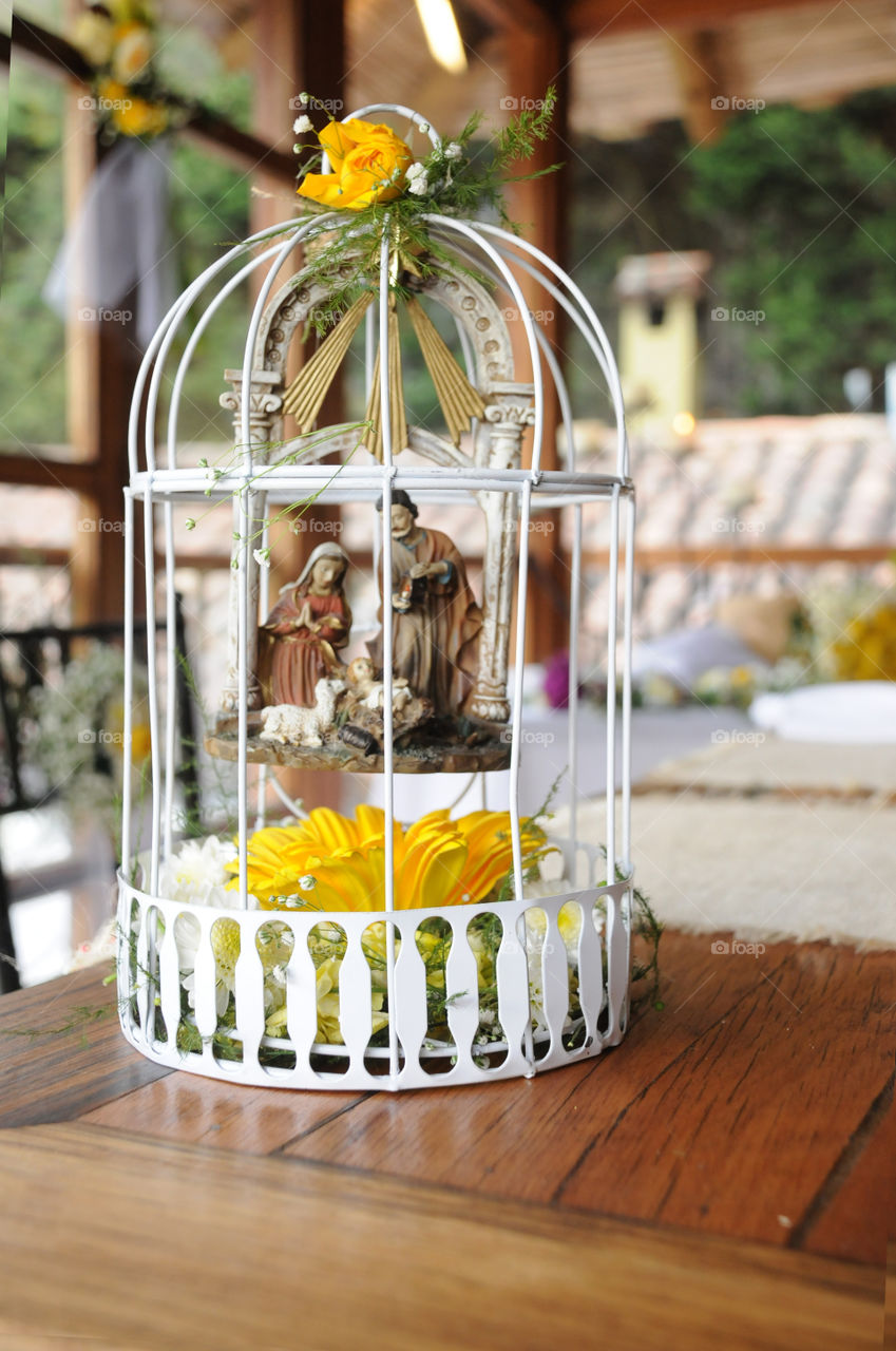 Cage decorated with Flowers in blurred background saints
