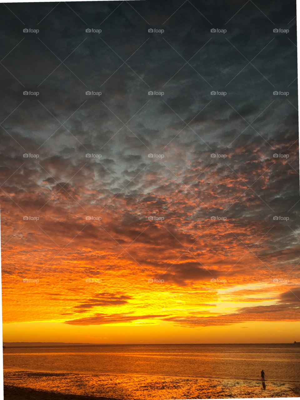 Sunset against Altocumulus clouds over the ocean