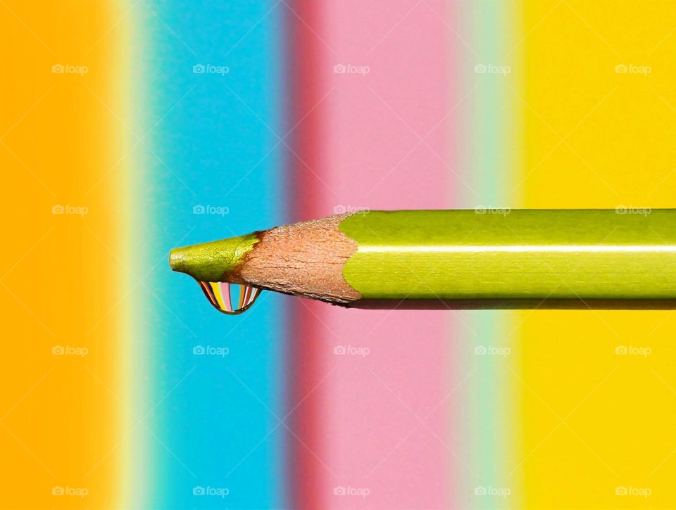 Water drop on the pen top on colorful background