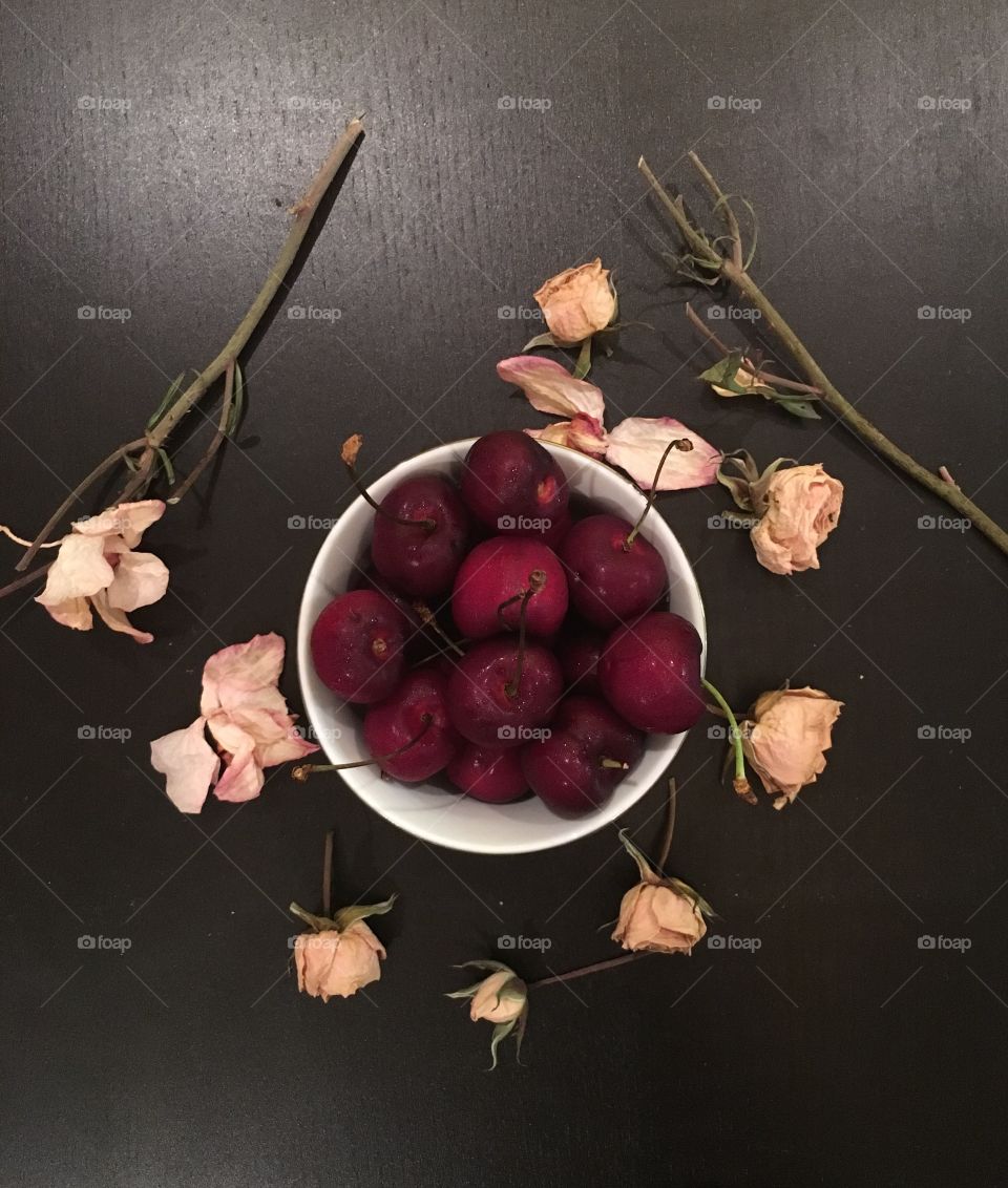 Cherries on top, of black table