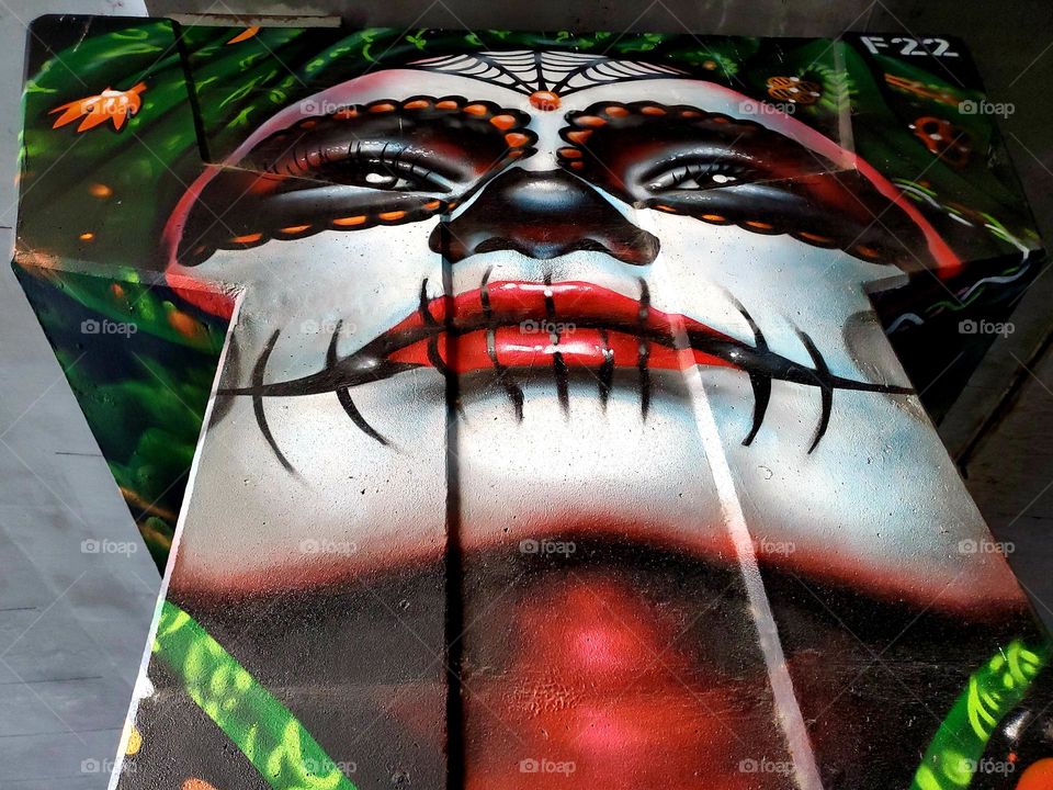 Close up of visual street art on a cement highway pillar celebrating Dia de los muertos/ Day of the dead. A Mexican cultural tradition of celebrating and remembering those that have passed. Artist: @PauLGaris0n13