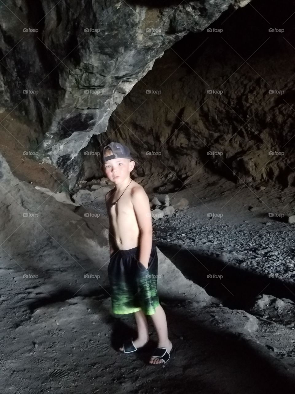 Boy poses inside Makua Cave