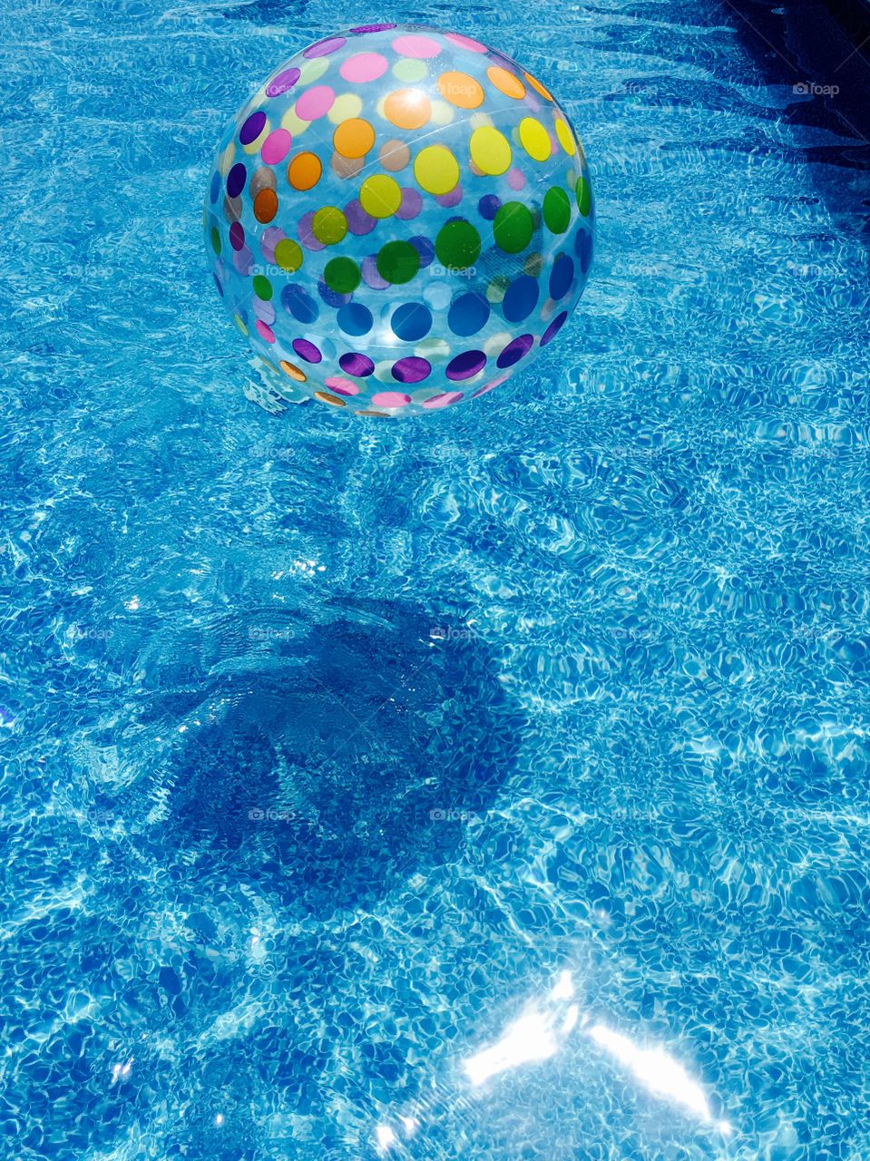 Colorful ball in water pool