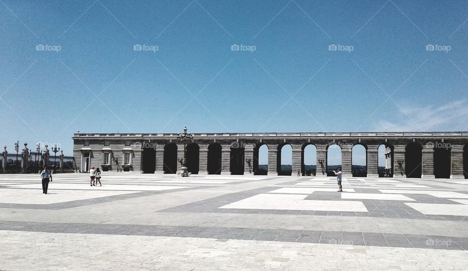 Grey bridge in the middle of a paved plaza. Minimalism.