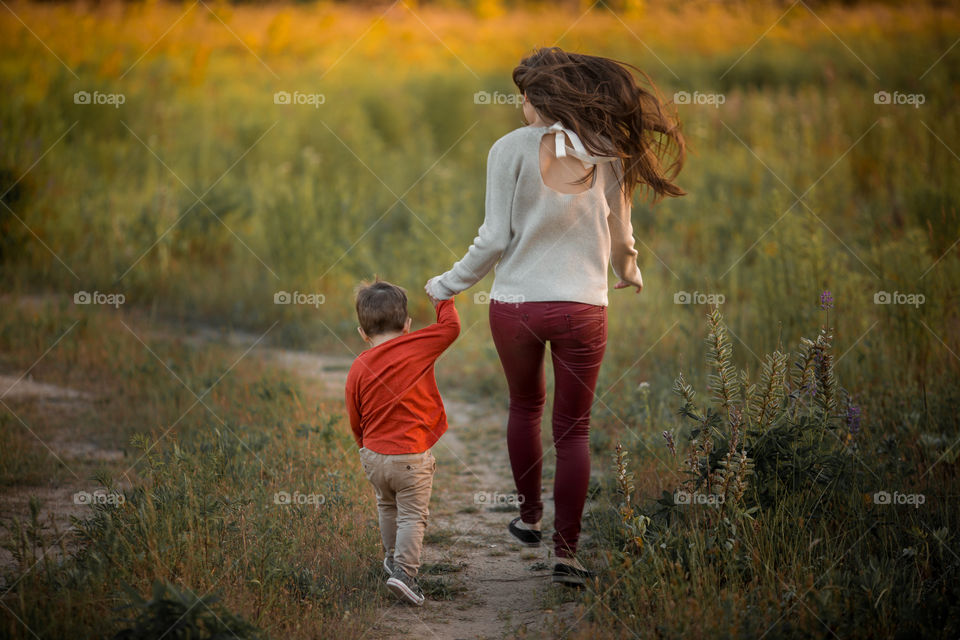 Mother with son  at sunset