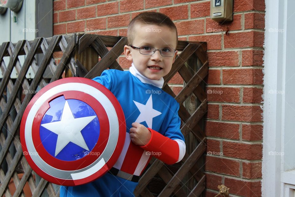 Cute child holding shield in hand
