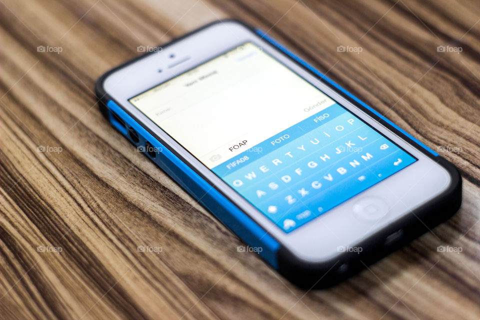 Close-up of a smart phone on wooden table