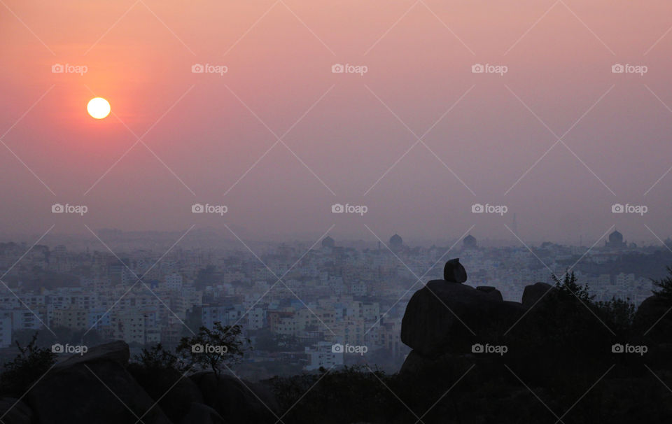 Sunrise view in a city from a hill through eye of camera