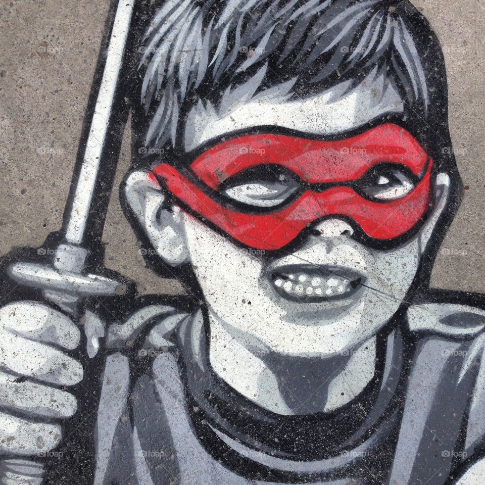 Street art. Sidewalk. Kid with mask airbrushed 
