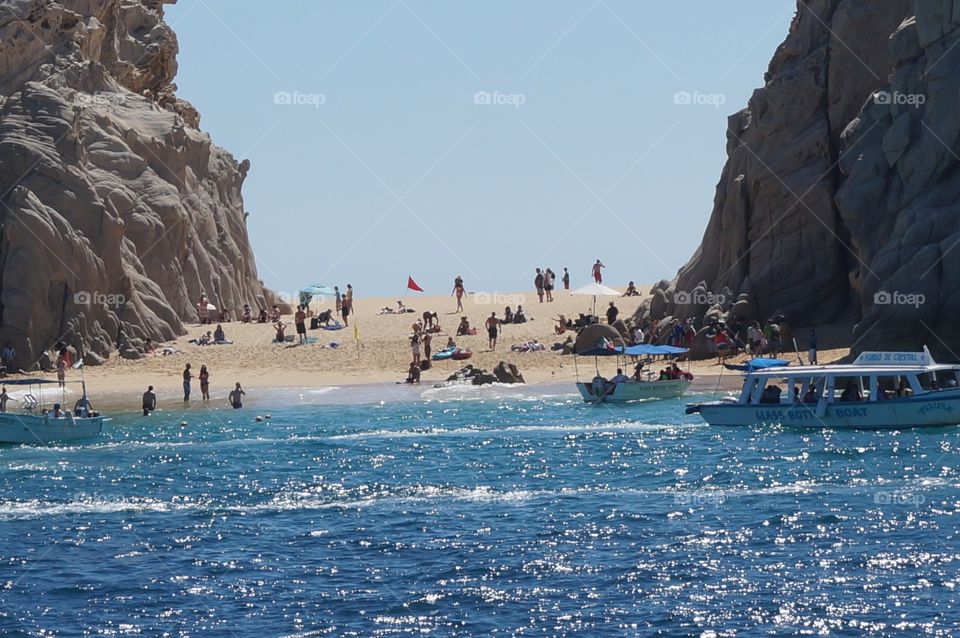 Beach through the rock formations.  Bay waters and ocean waters in Cabo, Mexico.