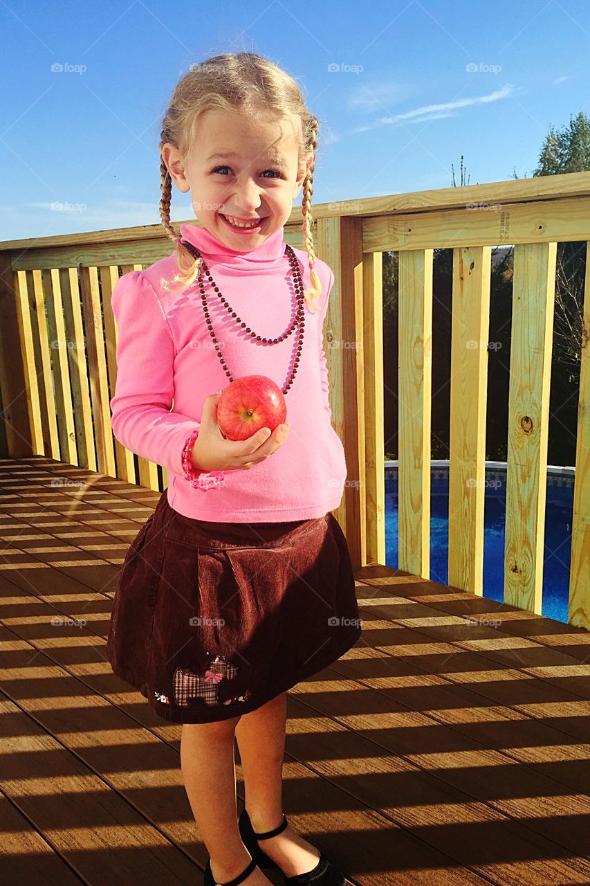 Happy girl standing on pier