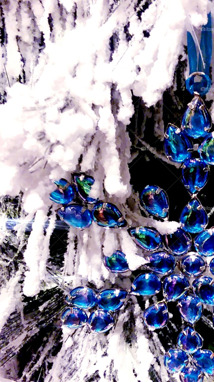 Christmas tree with snow and blue ornament