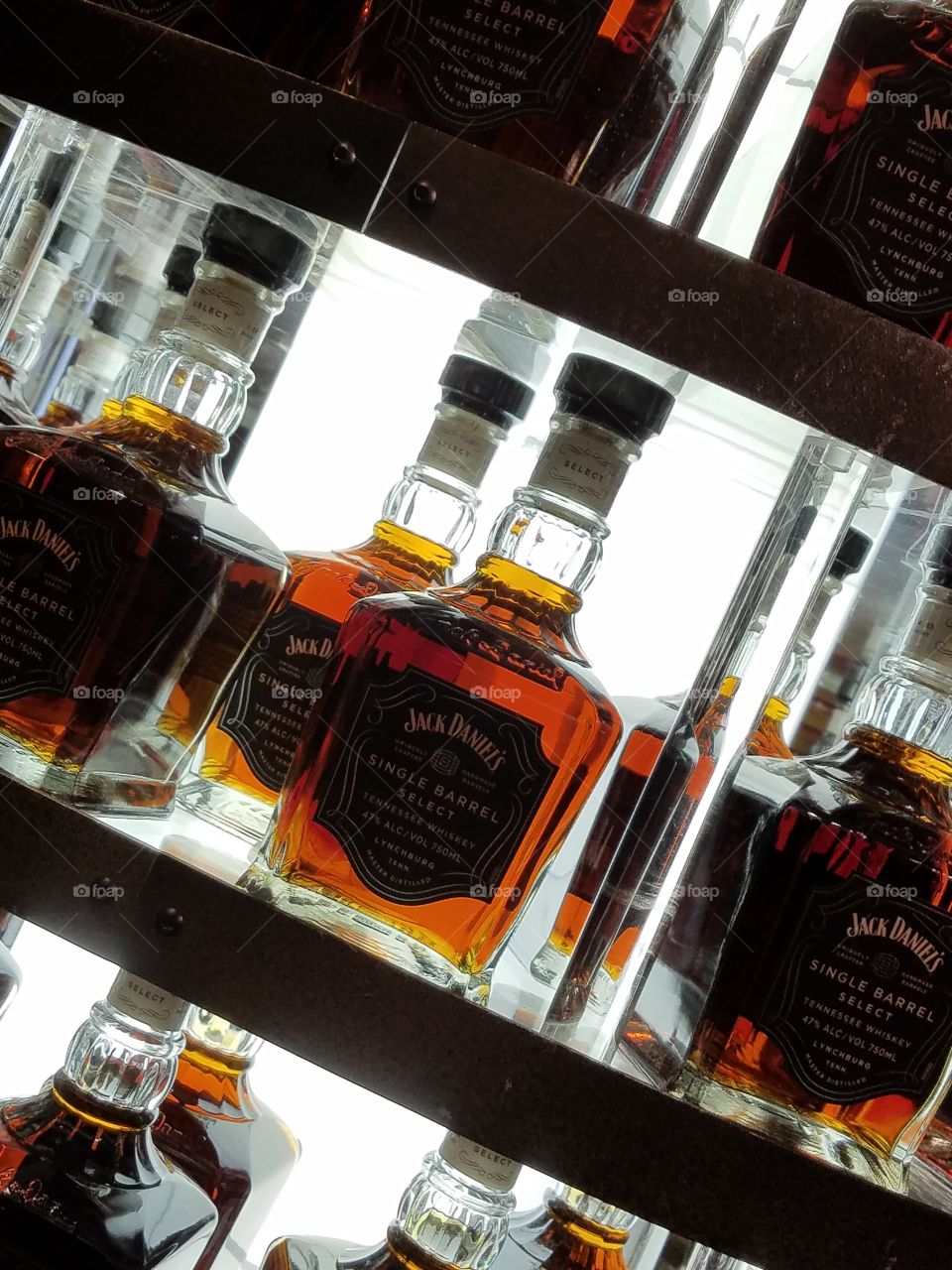 Jack Daniel's Whiskey Bottles back lite with white light to illuminate bottles from behind shot at an angle