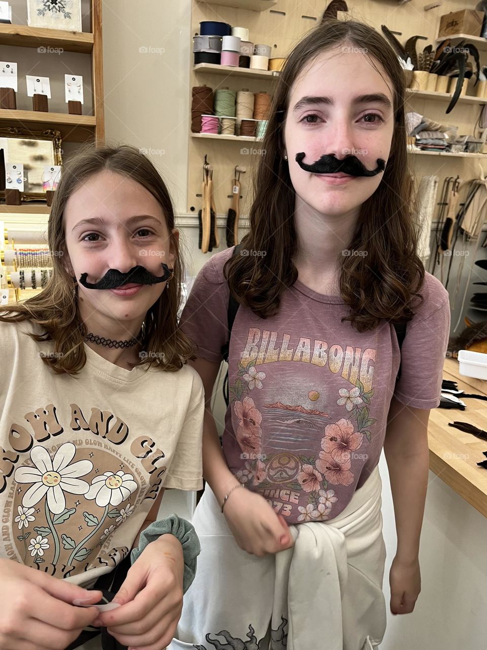 Two young girls grew mustaches while visiting a shop in the great Alaskan gold mining town called Skagway.