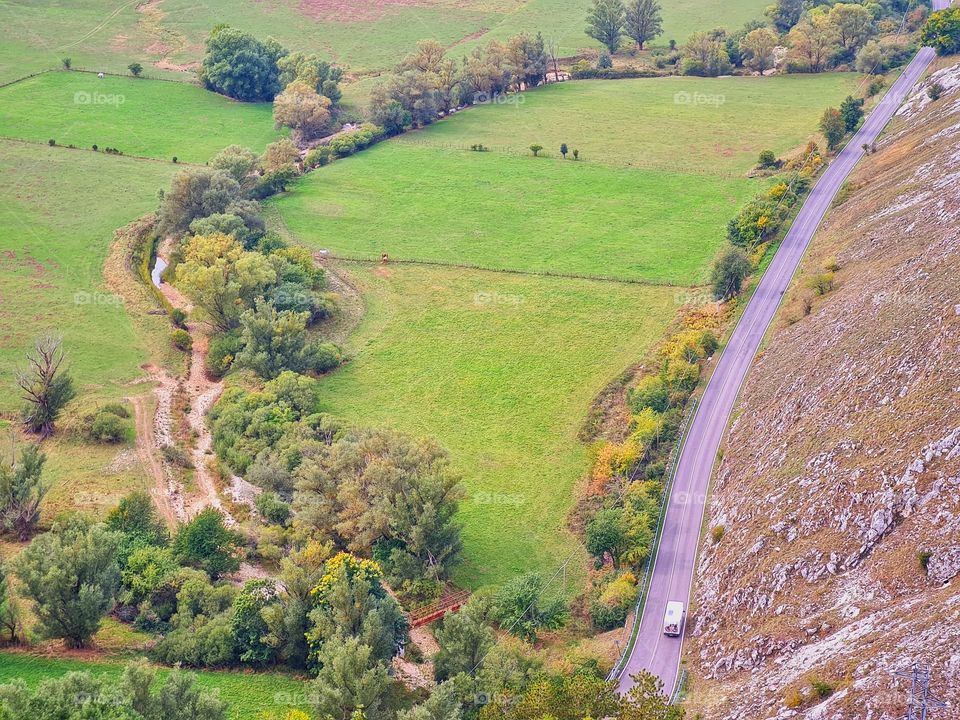 mountain road surrounded by greenery photographed from above
