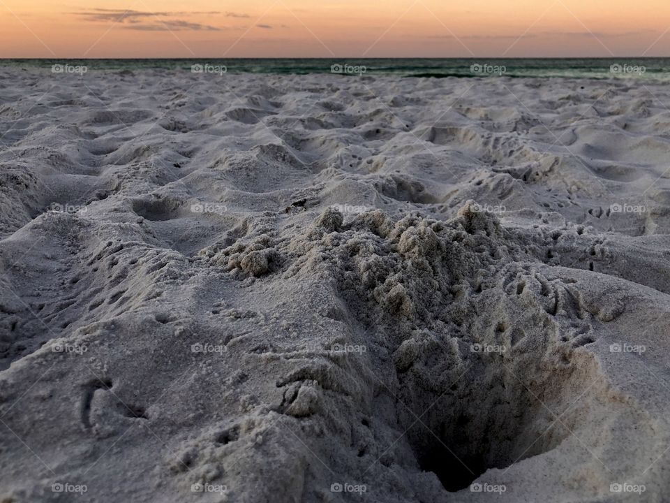 Ghost crab tracks towards the water at sunrise 