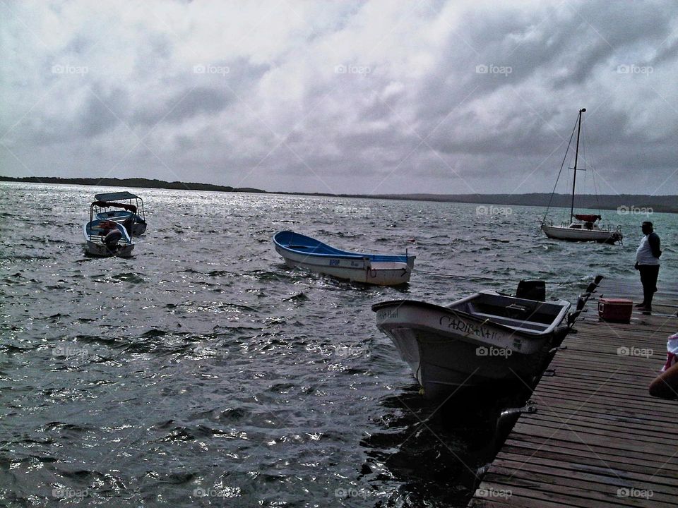 beautiful sunset, night falls and the boats rest tied to the shore