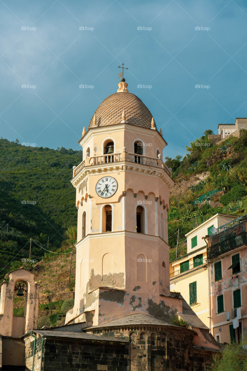 Bell tower of the Cinque Terre overlooking the sea. It has a watch that characterizes it.