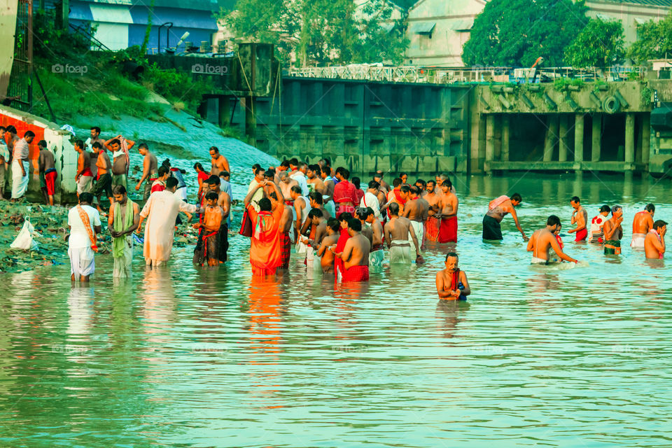 HARIDWAR, INDIA - JANUARY 14, 2016: Devotees taking holy dip at Har Ki Pauri on river Ganga on the first bath of Ardh Kumbh fair. People took a dip in holy Ganges on the occasion of Makar Sankranti
