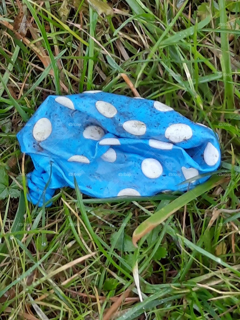 white dots on a blue burst balloon