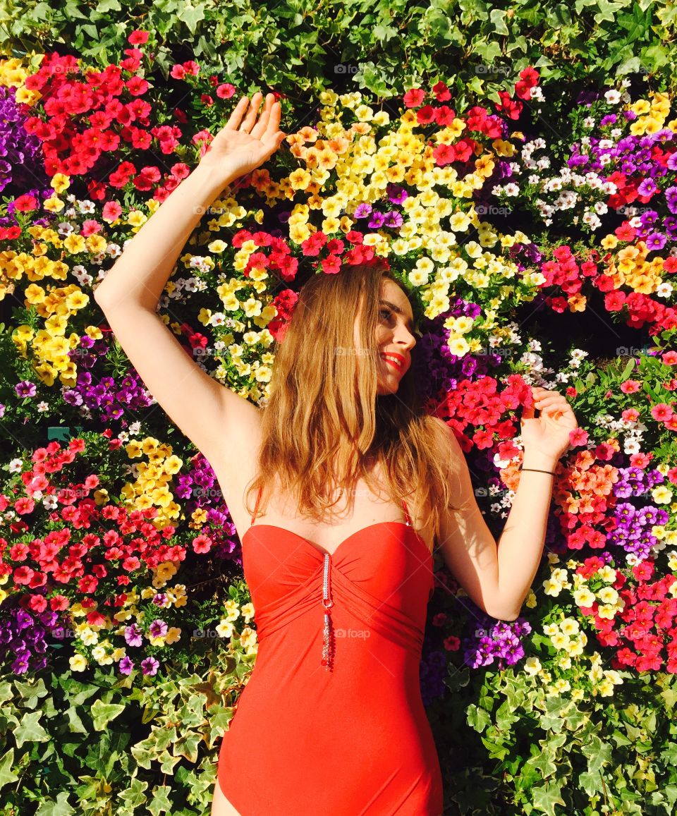 Beautiful woman lying on flower field