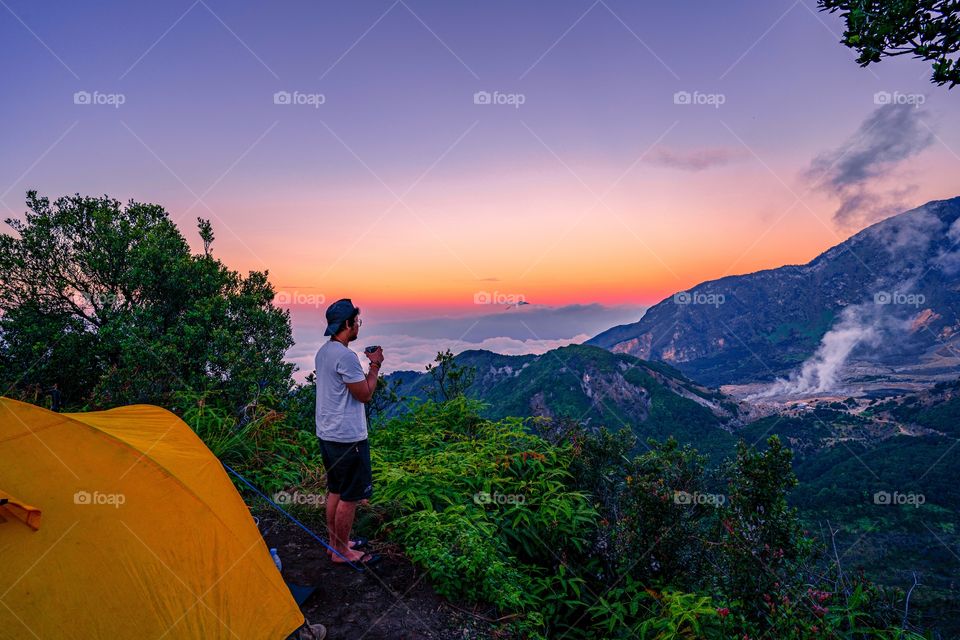 enjoying the sunset above the height of the mountain can make us calm and be a solution to improve mental health