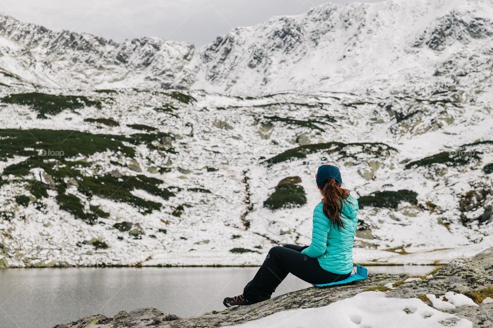 Woman admiring the views, while on a hike in the mountains.