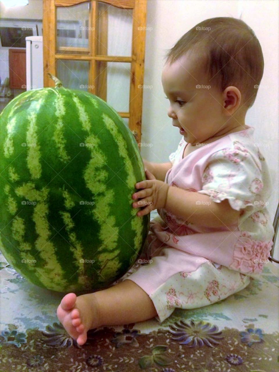 Baby playing with watermelon