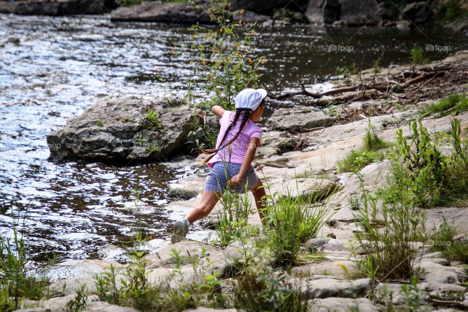 Girl is running by the river