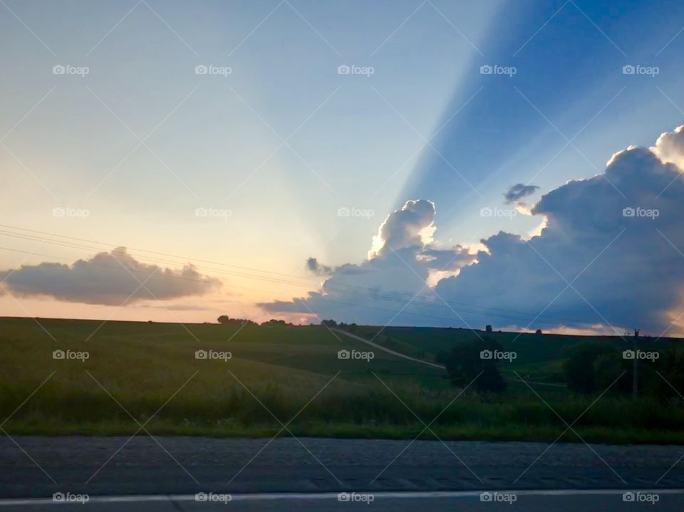 Beautiful sunset over a corn field in central Iowa just north of Newton. The rays over the clouds created a monumental shadow