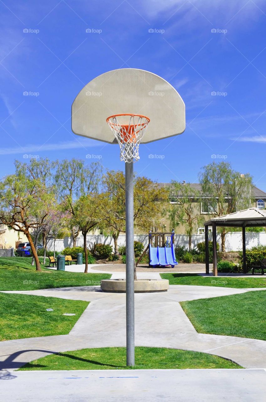Who's up for a game of hoops? Basketball hoop in a public park.