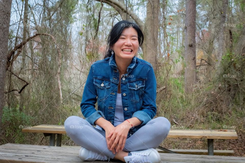 A Taiwanese lady is happy to be at the park. 