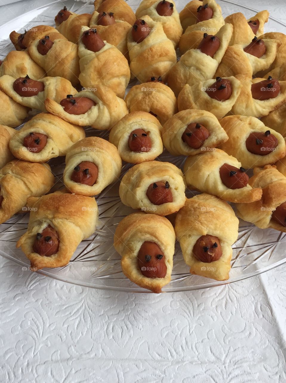 Appetizers on tray called babies in the blanket.
