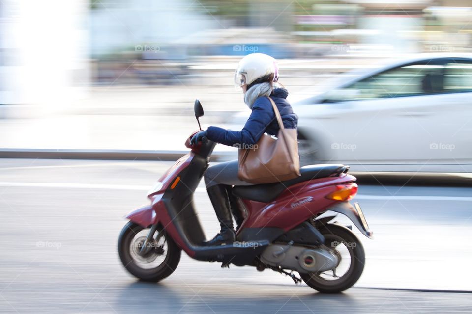 Woman on scooter.